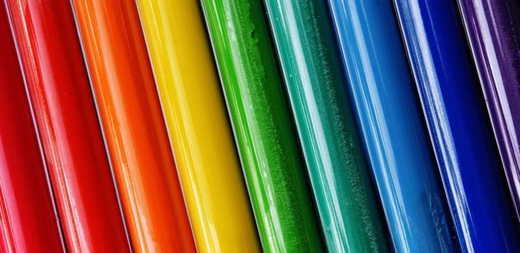 Close-up of brightly colored paint tubes arranged in a rainbow pattern.
