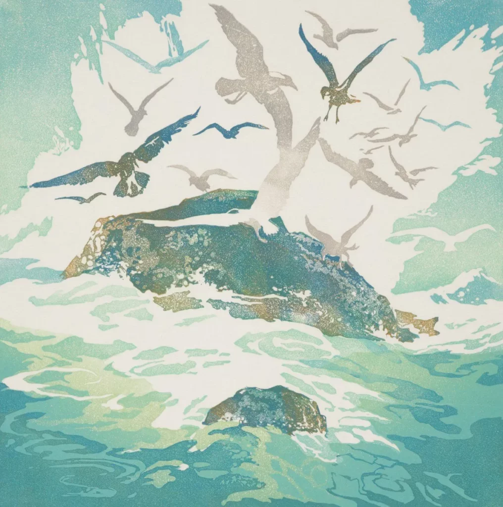 Seagulls fly around a rocky island in the ocean.