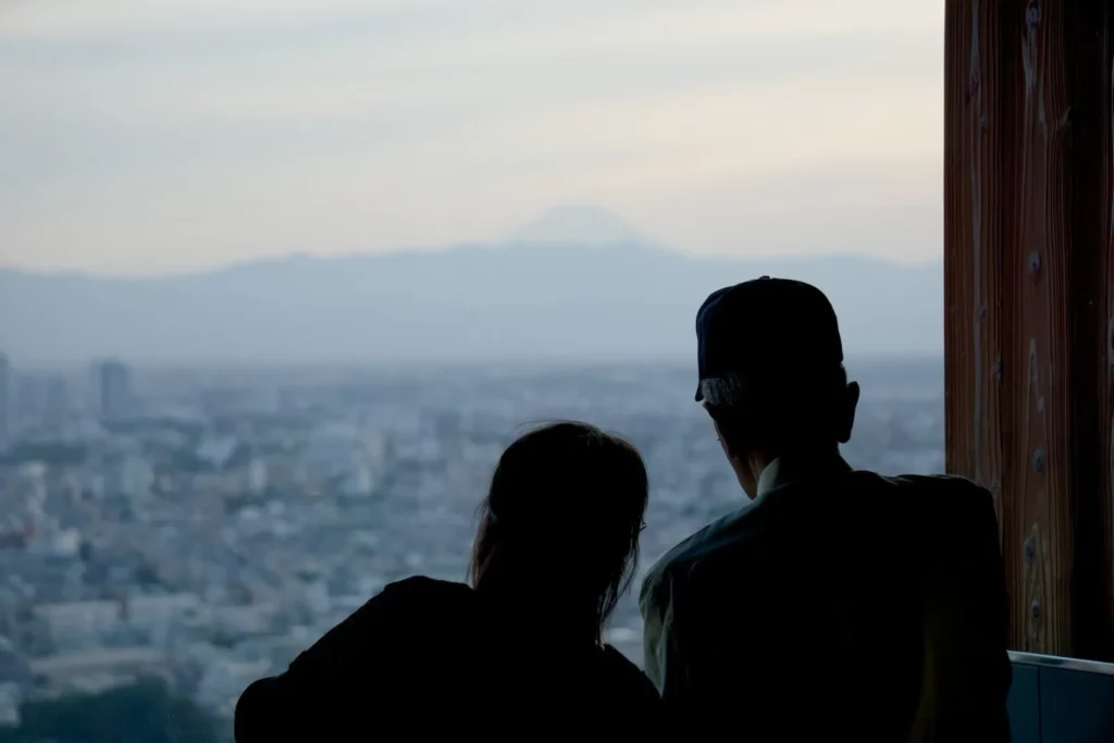 a couple of people that are looking out a window