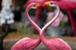 two pink flamingo ceramic figurines
