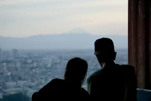 a couple of people that are looking out a window